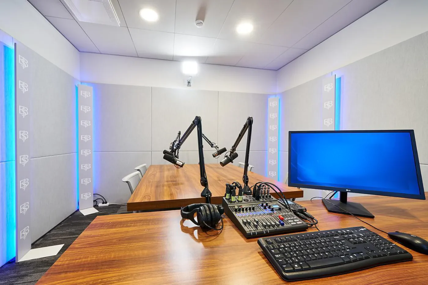 The Eedu podcast studio with microphones, a mixer and a screen
